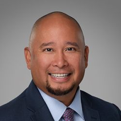 Headshot of Jayvee Gulmatico, smiling professionally.