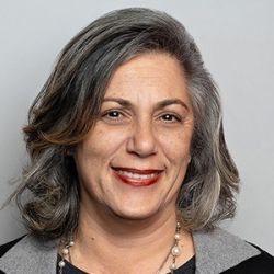 Headshot of Odette Dayans, smiling professionally.